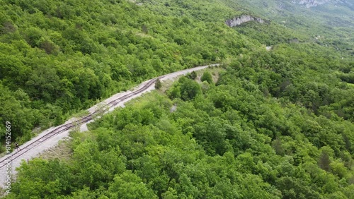 Pijana pruga or drunk railway in Istria, Croatia. A stretch of neglected railway track and bed, deformed rails, washed down by land slide or poor earth base photo