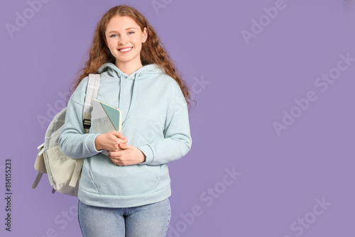 Happy female student with b...