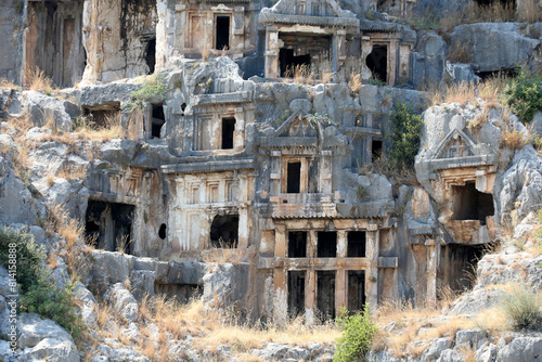 Rocks with caves for the burial of people. Ruins of the ancient city Myra. Lycia region, Antalya, Turkey. photo
