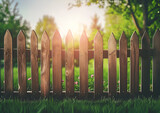 A wooden fence standing in the middle of a beautiful grassy field. Perfect for nature and rural landscape themes. Making a wooden fence in the garden.