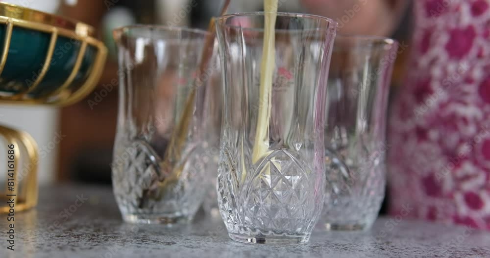 Condensed milk in a glass Iron spoon with condensed milk on a dark background Condensed milk in a glass Iron spoon with condensed milk on a dark background