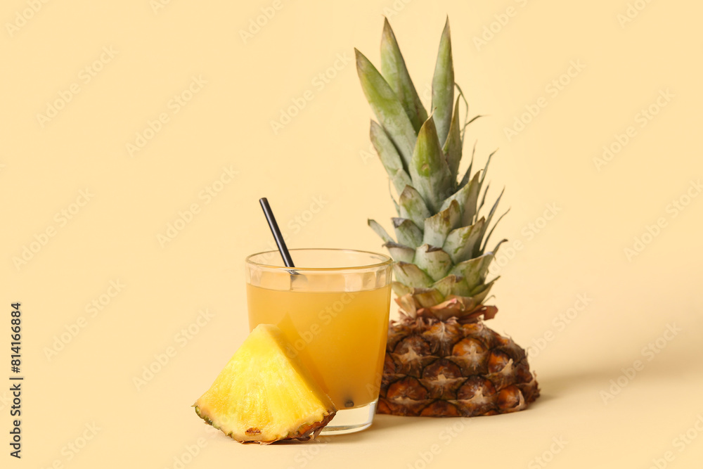 Glass of fresh tasty pineapple juice on beige background Glass of fresh tasty pineapple juice on beige background