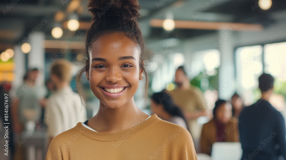 of pretty smiling girl standing in office looking at camera while people multi-ethnic team are working in background. of pretty smiling girl standing in office looking at camera while people multi-ethnic team are working in background.