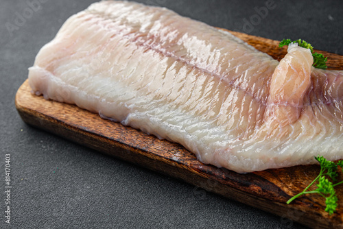 raw white fish fillet giant sea bass and filleting grouper fresh cooking appetizer meal food snack on the table copy space food background rustic top view Pescetarian diet vegetarian food