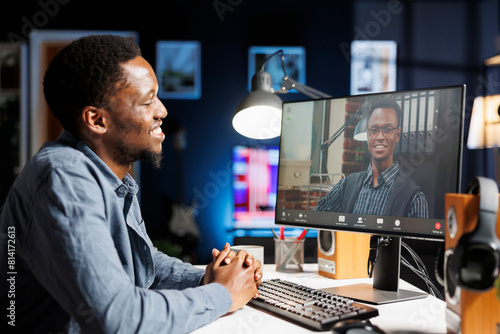 Job recruiter asking questions at online interview on videocall, meeting with young applicant on remote telework conference. Management staff having discussion with african american person. © DC Studio