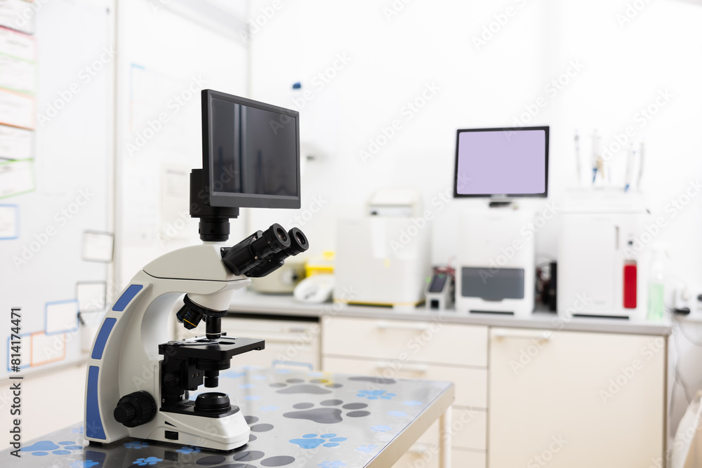 Modern digital trinocular microscope standing on table in veterinary clinic laboratory for detailed and in-depth diagnostic research. Concept of conducting professional medical diagnostics for pets..