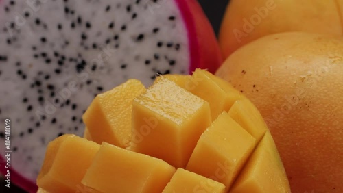 A mango and a Costa Rican pitahaya are on the cutting board photo