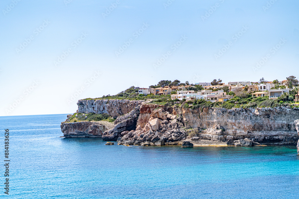The coast of Cala D'or in South of Mallorca Spain in summer time on a sunny day with blue water and rocks The coast of Cala D'or in South of Mallorca Spain in summer time on a sunny day with blue water and rocks