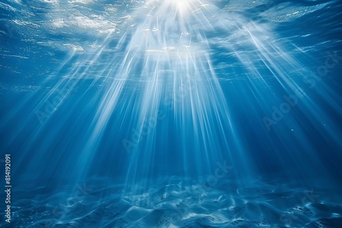 sunbeams penetrating deep blue sea or ocean underwater light rays background © Lucija