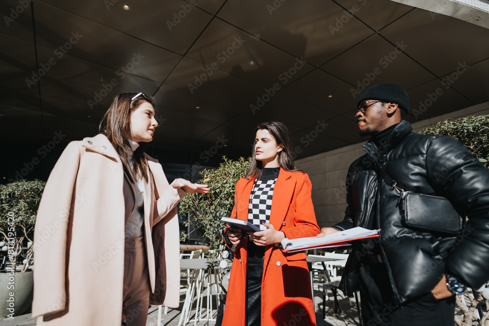 Multiracial group of people in a casual meeting outside their office, engaging in a discussion with a sense of teamwork. Multiracial group of people in a casual meeting outside their office, engaging in a discussion with a sense of teamwork.