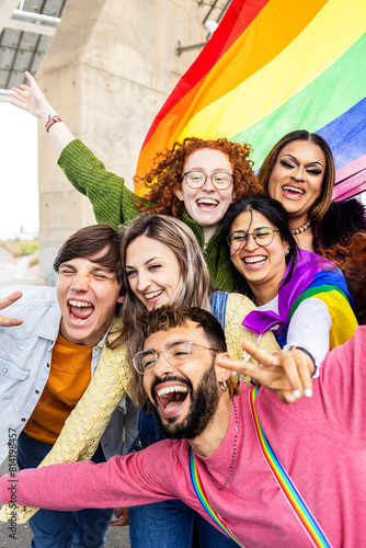 Happy gay group of young people celebrating gay pride day festival. LGBT community concept