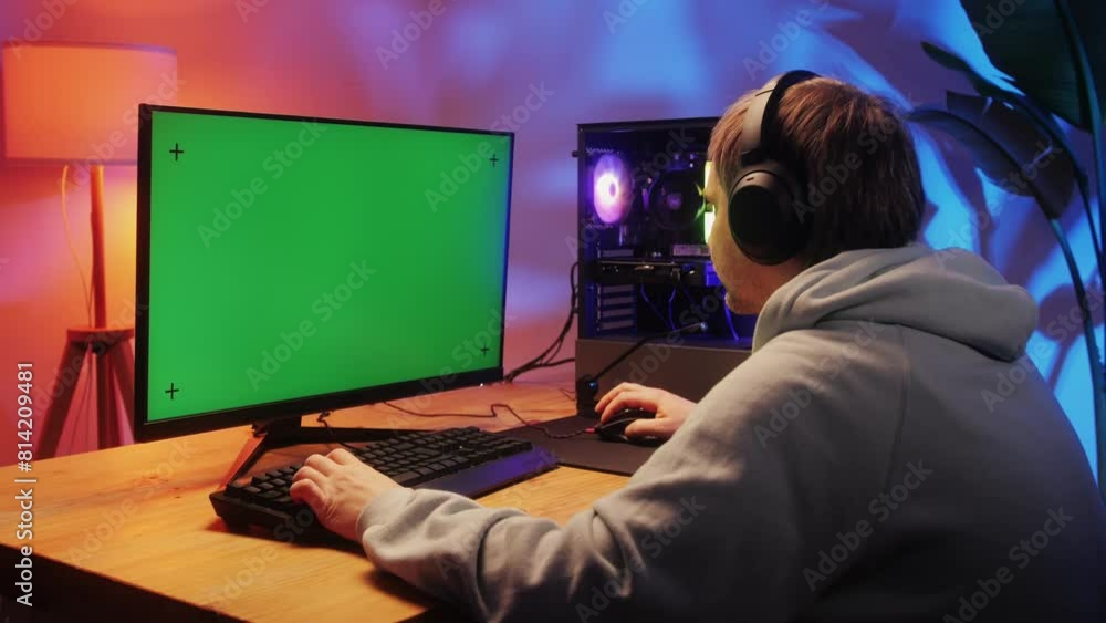 Computer with chroma key green screen on monitor. Gamer man playing in popular video games. Programmer or hacker coding a code and working in networks, cyberspace. Digital software, mobile app Computer with chroma key green screen on monitor. Gamer man playing in popular video games. Programmer or hacker coding a code and working in networks, cyberspace. Digital software, mobile app