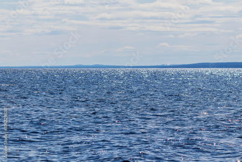 Spring landscape of the water of large Lake Onega on a sunny day at noon.