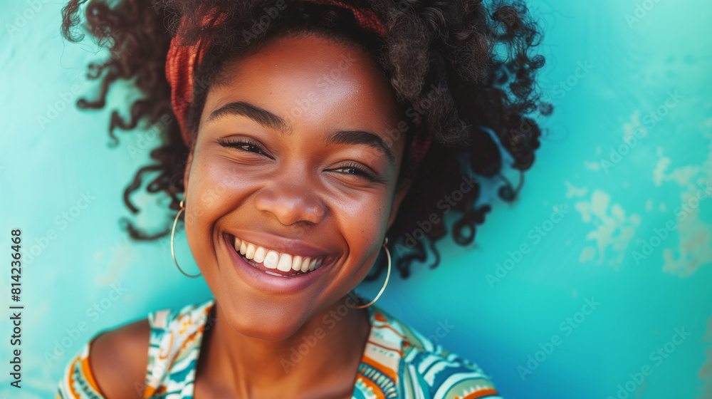 Smiling African Woman Against Blue Wall Smiling African Woman Against Blue Wall