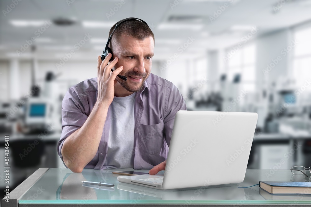 Smiling happy call center worker wearing headset Smiling happy call center worker wearing headset