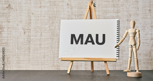 There is notebook with the word MAU. It is an abbreviation for Monthly Active Users as eye-catching image.