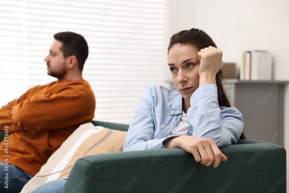 Offended couple ignoring each other after quarrel indoors, selective focus. Relationship problems Offended couple ignoring each other after quarrel indoors, selective focus. Relationship problems