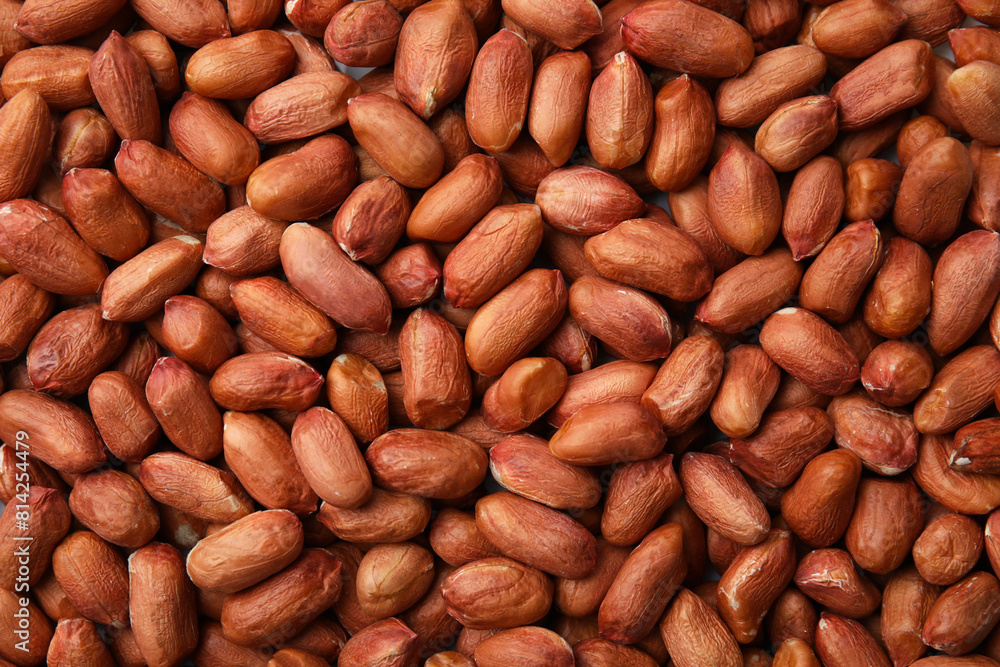 Many fresh unpeeled peanuts as background, top view Many fresh unpeeled peanuts as background, top view
