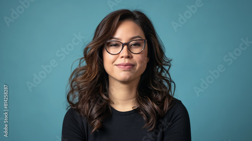 Confident Latina female customer with medium-length brown hair and glasses, headshot on a serene blue backdrop, radiating positivity. © USAMA