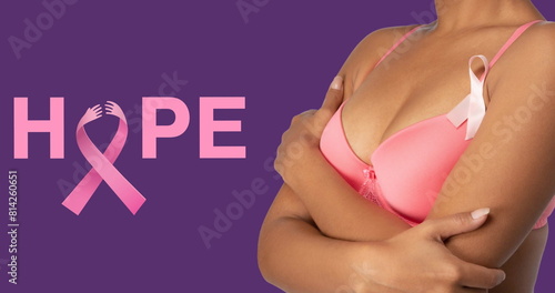 Image of breast cancer awareness text over woman covering breast