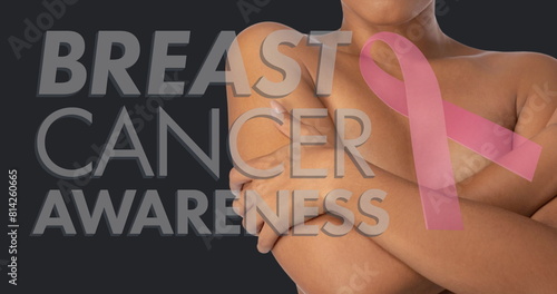 Image of breast cancer awareness text over woman covering breast