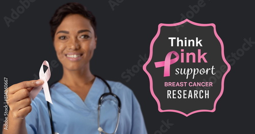 Image of breast cancer awareness text over female doctor