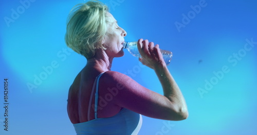 Image of blue lights over caucasian women drinking water