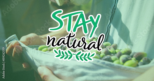 Image of stay natural text over caucasian man picking fruit