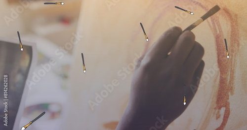 Image of brush icons over hands painting
