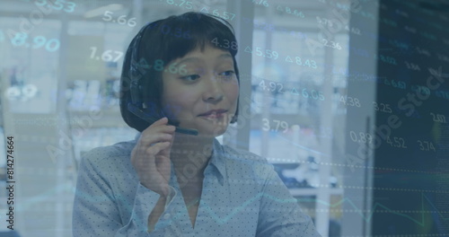 Image of stock market data processing over asian woman talking on phone headset at office