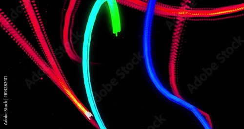 Image of blue, green, orange and red light trails moving on black background