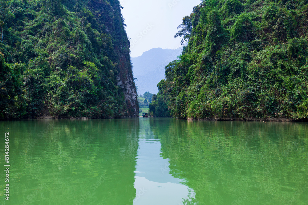 River in the mountains. Calm green river between high rock hills in Ha Giang, Vietnam. Beautiful landscape of Ha Giang, North Vietnam. Canyon river. River in the mountains. Calm green river between high rock hills in Ha Giang, Vietnam. Beautiful landscape of Ha Giang, North Vietnam. Canyon river.