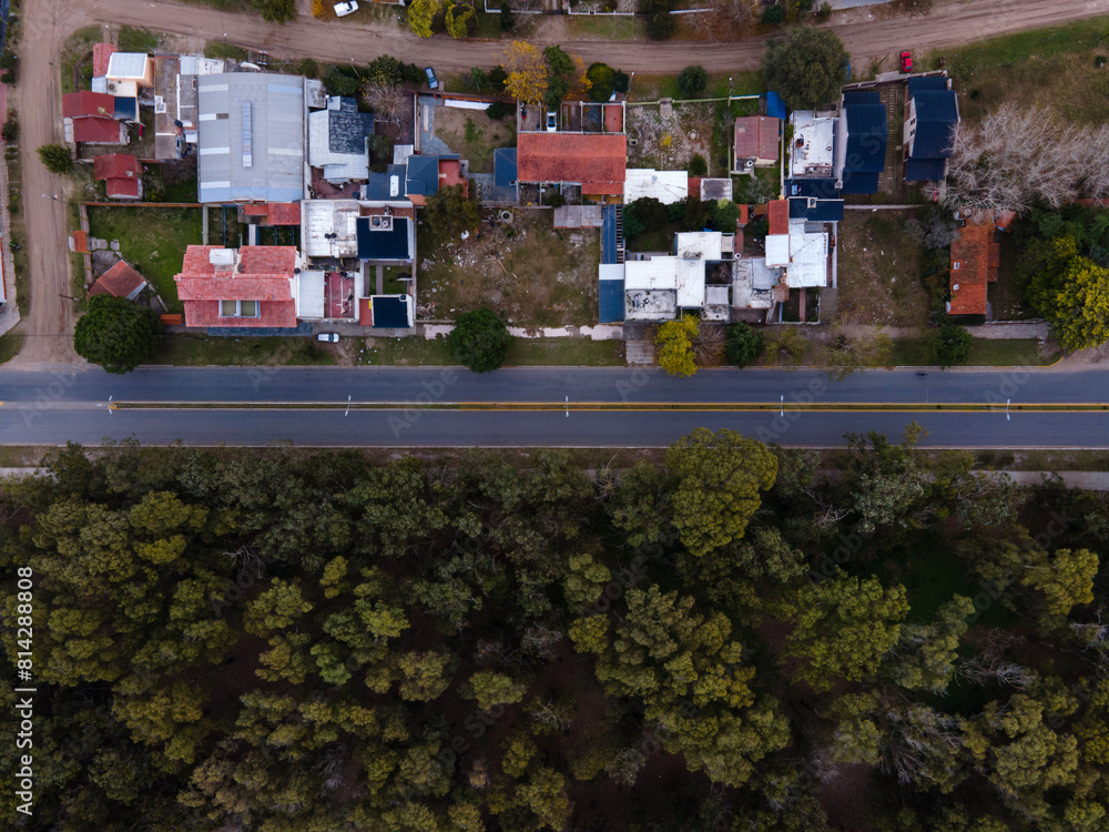 Road seen from the air vertically separated by trees and houses. Road seen from the air vertically separated by trees and houses.