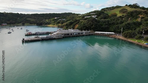 Matiatia Ferry Terminal On Matiatia Bay In Waiheke Island, Auckland, New Zealand. aerial pullback shot photo