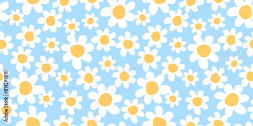 Seamless pattern with chamomile flowers on blue background. 1970s trippy daisy pattern. Design for textile, wrapping paper, wallpaper.