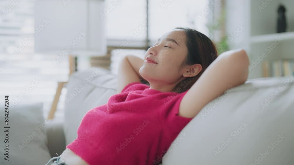 Relaxed young Asian woman enjoying rest on comfortable sofa, calm attractive girl relaxing on couch, breathing fresh air with eyes closed, meditating at home Relaxed young Asian woman enjoying rest on comfortable sofa, calm attractive girl relaxing on couch, breathing fresh air with eyes closed, meditating at home