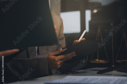 Lawyer  legal advisor  businessman brainstorming information on agreement details Business contracts in legal processing books for accuracy in contract documents. joint financial investment.