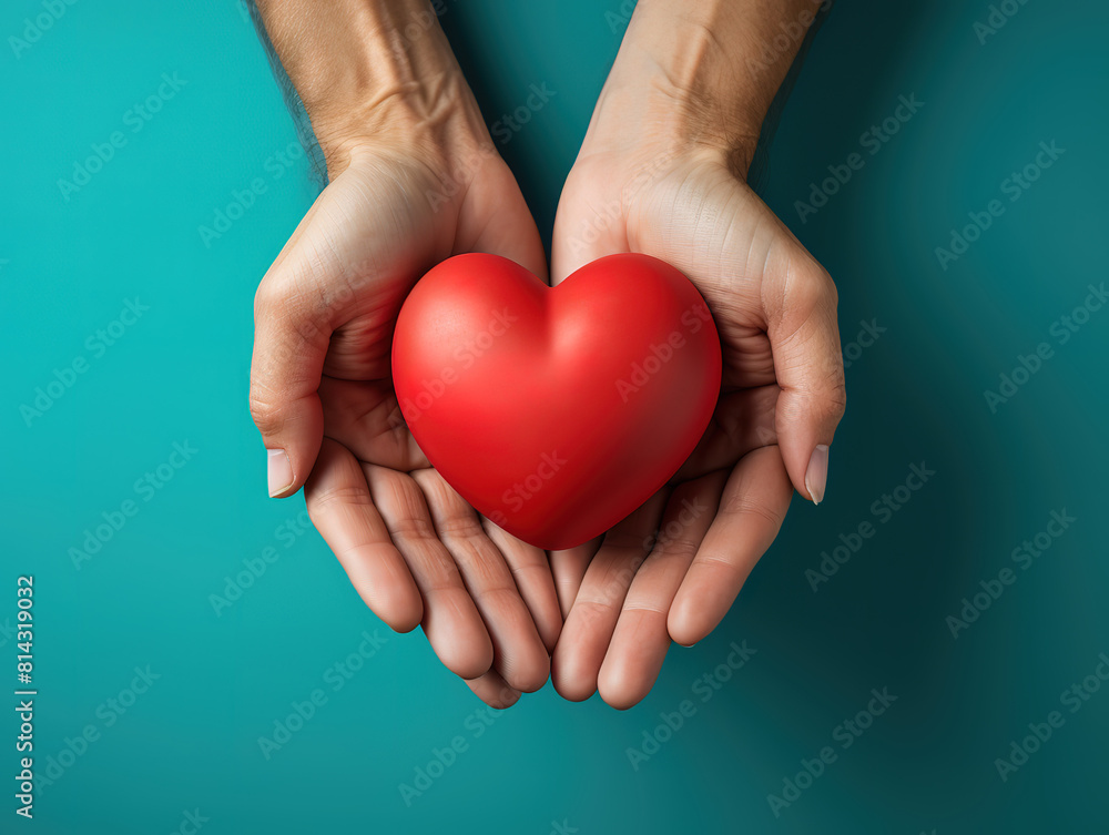 Top view of pair of hands holding heart shape with care Top view of pair of hands holding heart shape with care