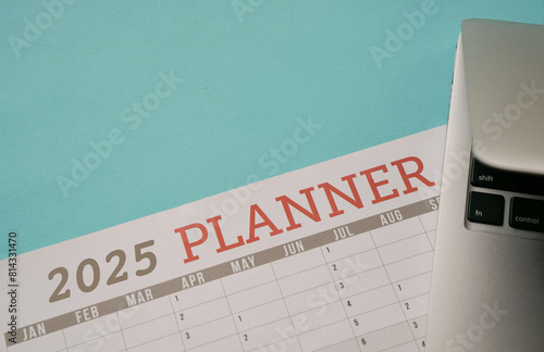 2025 Planner next to a computer laptop