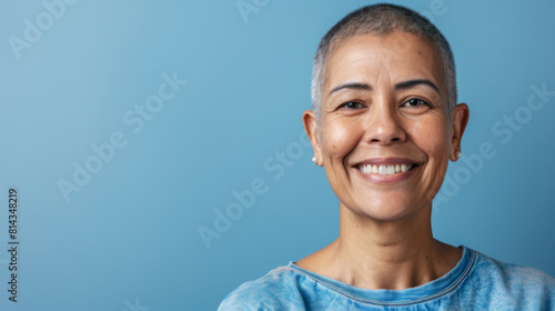 A woman with a shaved head is smiling, cancer patient with chemotherapy photo