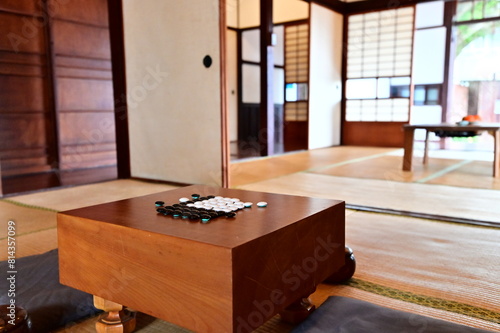 Immerse yourself in the tranquility of a Japanese-style room, where tatami mats, low tables, and a set of go pieces on a wooden board create an atmosphere of harmony and thoughtful contemplation.