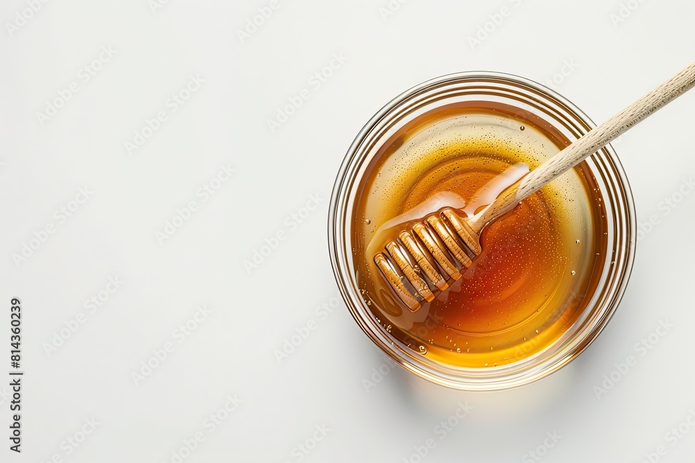 Glass bowl of honey with honey dipper isolated on white background. top view Glass bowl of honey with honey dipper isolated on white background. top view
