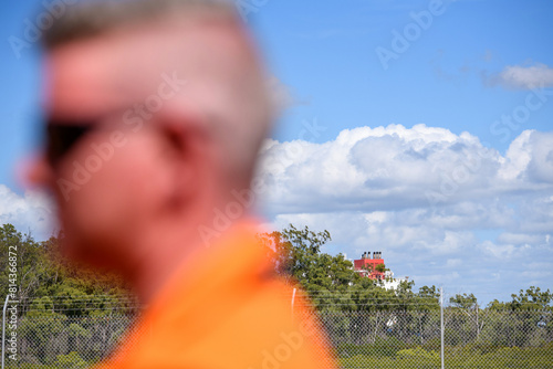 worker out of focus with liquid natural gas ship in the background