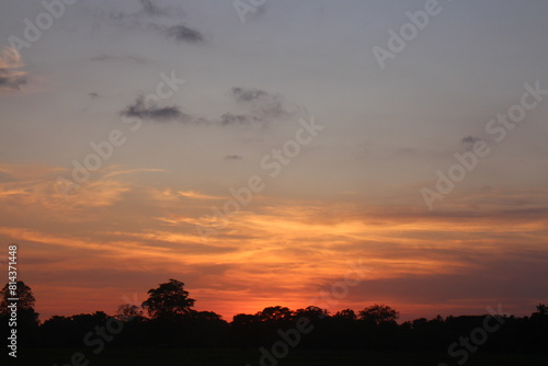 Sunset Sky Clouds in the evening with Red, Orange, Yellow and purple sunlight on Golden hour after sundown, Romantic sky in summer on Dusk Twilight © SISIRA