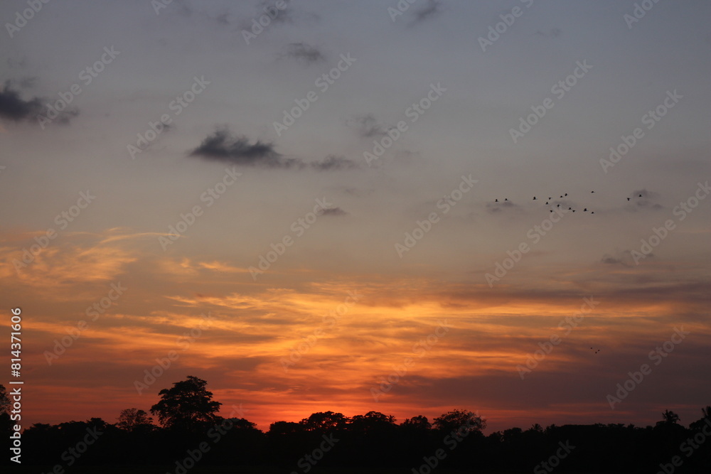 Obraz premium Sunset Sky Clouds in the evening with Red, Orange, Yellow and purple sunlight on Golden hour after sundown, Romantic sky in summer on Dusk Twilight