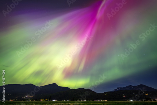 Northern lights vibrant colors over a mountain range © peteleclerc