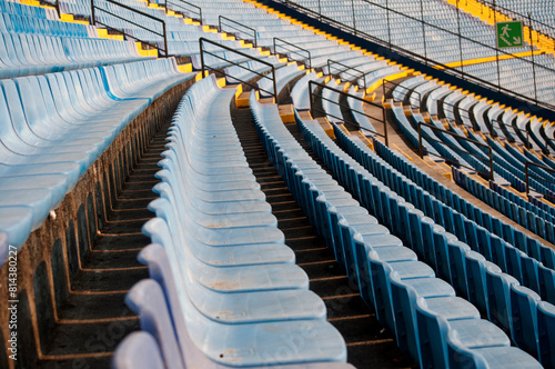 Empty seats in a soccer stadium in Latin America, a structure built amidst a ravine, providing space for both sporting and musical events.