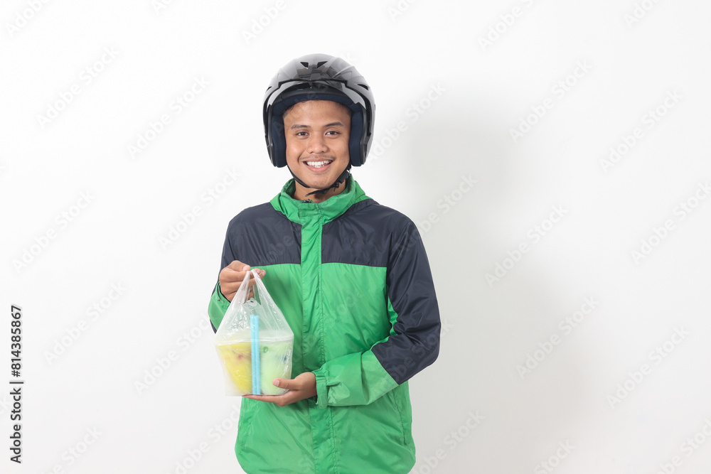 Portrait of Asian online taxi driver wearing green jacket and helmet delivering the beverages in plastic cup to customer. Isolated image on white background Portrait of Asian online taxi driver wearing green jacket and helmet delivering the beverages in plastic cup to customer. Isolated image on white background