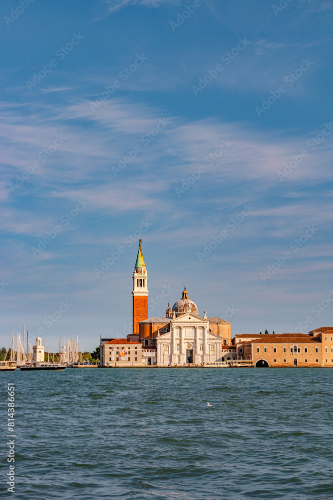Venice, Italy. Cover page with beautiful Church of San Giorgio Maggiore and its Bell Tower at sunset illumination, and blue sky
