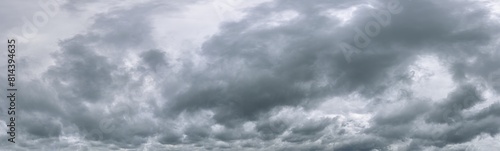 dramatic dark clouds before rain and thunderstorm. wide panoramic image.